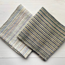 Load image into Gallery viewer, Two woven mats with striped patterns on a light wooden surface