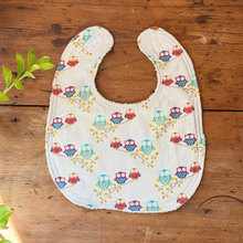 Load image into Gallery viewer, Baby bib with owl pattern on a wooden surface