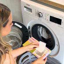 Load image into Gallery viewer, Woman using a Bosch washing machine with detergent in a laundry room.