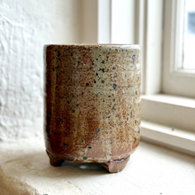 Load image into Gallery viewer, Speckled brown ceramic pot on a windowsill with a soft focus background