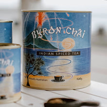 Load image into Gallery viewer, Byron Chai Indian Spiced Tea can with artistic label on a blurred background
