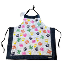 Load image into Gallery viewer, Colorful apron with floral patterns on a beige surface
