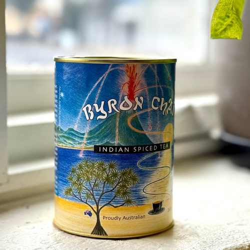 Byron Bay Indian Spiced Tea can on a windowsill with a blurred outdoor background