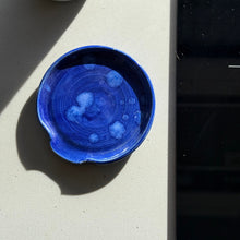 Load image into Gallery viewer, Blue ceramic bowl on a light surface with a black object in the background
