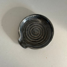 Load image into Gallery viewer, Black ceramic dish with spiral design on a light gray surface
