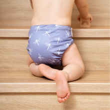 Load image into Gallery viewer, Child wearing a purple diaper with white patterns on wooden steps
