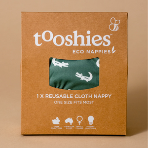 Box of tooshies eco nappies with a green reusable cloth nappy on a brown background