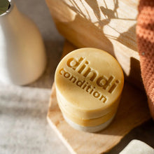 Load image into Gallery viewer, Bar of soap with 'dindi condition' branding on a wooden surface.
