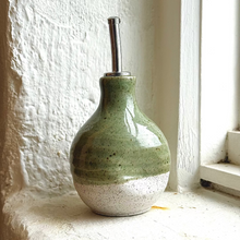 Load image into Gallery viewer, green and white oil bottle on window seal with white background

