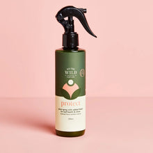 Load image into Gallery viewer, Bottle of &#39;We the Wild&#39; plant spray on a pink background
