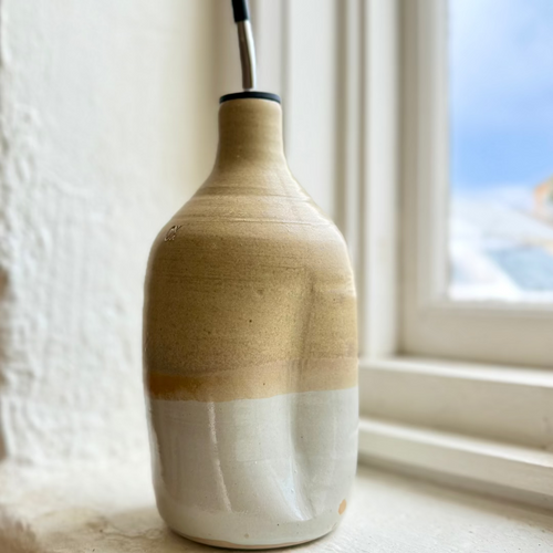 Ceramic vase with two-tone design on a windowsill