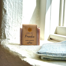 Load image into Gallery viewer, Sunnee Bee Frankie soap bar on a windowsill with natural light
