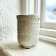 Load image into Gallery viewer, Speckled ceramic cup on a light surface with a blurred window background
